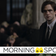 A dour Bruce Wayne looks on at a funeral.